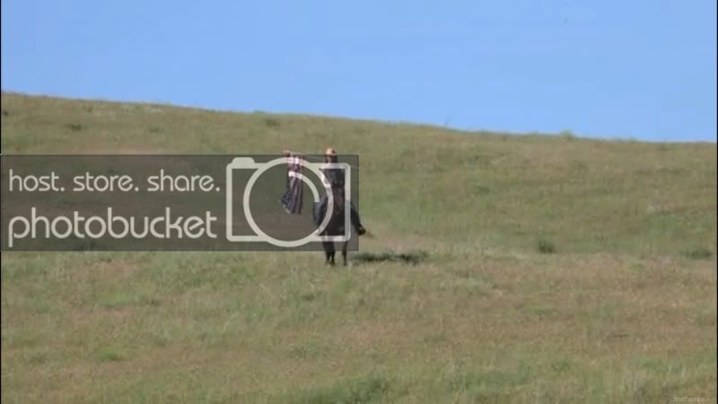 Custer actor rides in with flag